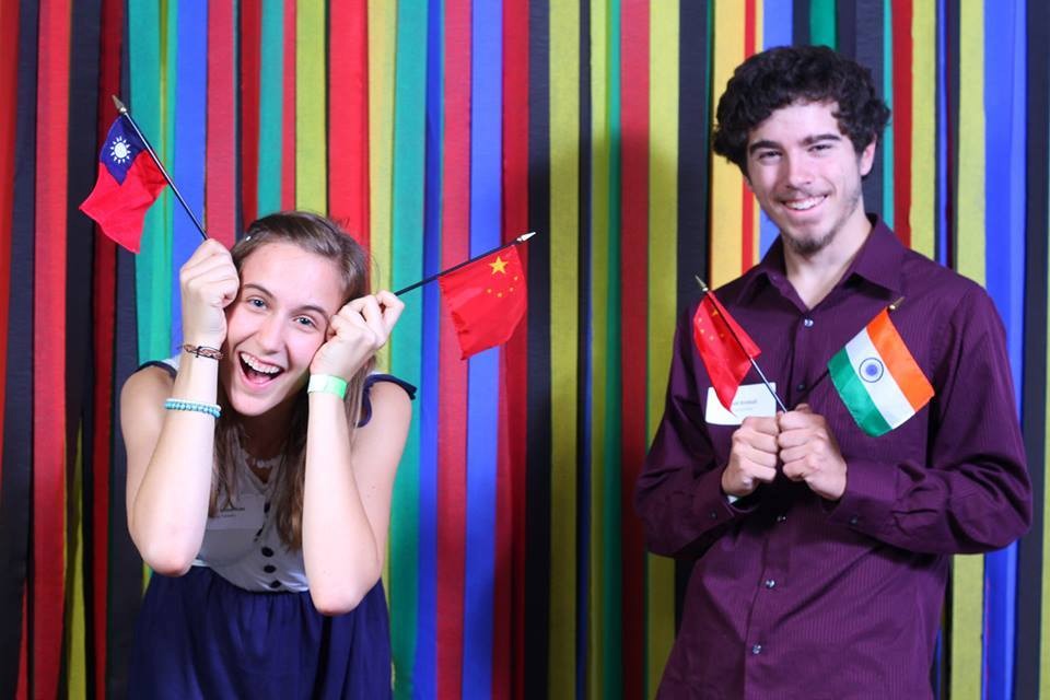 Man and woman smiling holding a China, India, and Taiwan flag